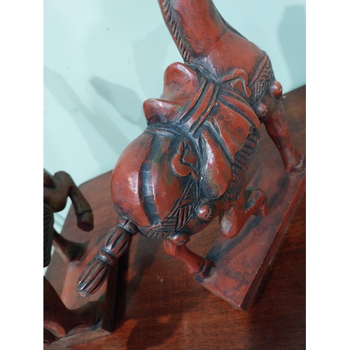 45 - Two carved painted pine models of Oriental Horses. {27 cm H x 28 cm W x 12 cm D}.