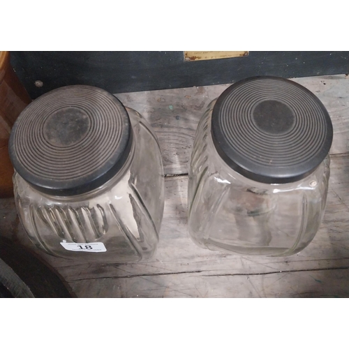 18 - Two 1950's glass sweet jars with bakelite lids. {24 cm H x 12 cm W x 12 cm D}.
