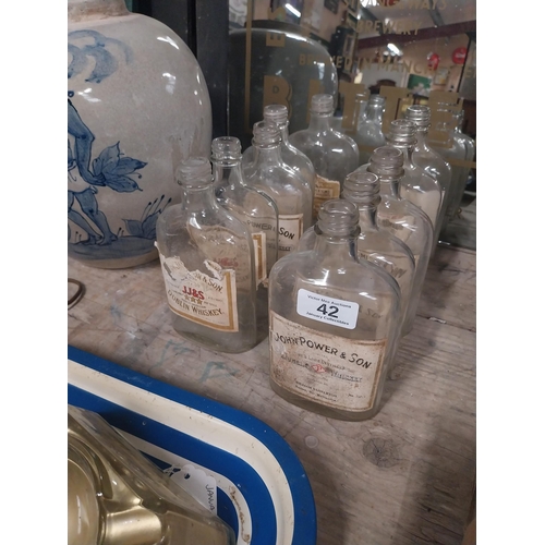 42 - Ten 1960's John Power and Sons bottles with original labels. {17 cm H x 9 cm W x 4 cm D}.