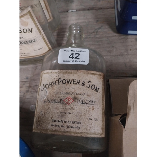 42 - Ten 1960's John Power and Sons bottles with original labels. {17 cm H x 9 cm W x 4 cm D}.