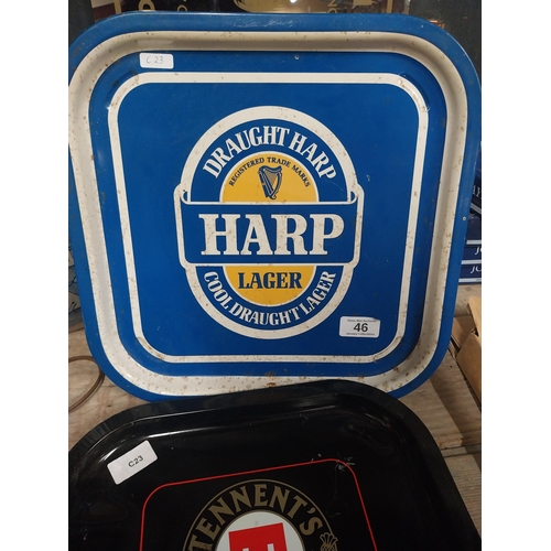 46 - Harp Lager and Tennent's Lager tin plate advertising drinks trays. {34 cm H x 34 cm W}.