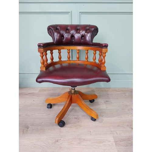 124 - Mahogany and deep buttoned leather upholstered office chair. {90 cm H x 63 cm W x 55 cm D}.