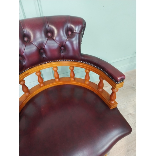 124 - Mahogany and deep buttoned leather upholstered office chair. {90 cm H x 63 cm W x 55 cm D}.