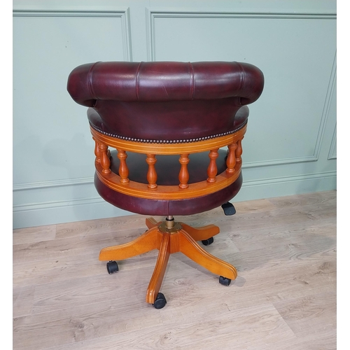 124 - Mahogany and deep buttoned leather upholstered office chair. {90 cm H x 63 cm W x 55 cm D}.