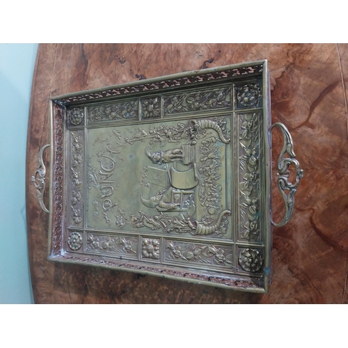 111 - Edwardian embossed brass Punch and Judy serving tray. {5 cm H x 36 cm W x 23 cm D}.
