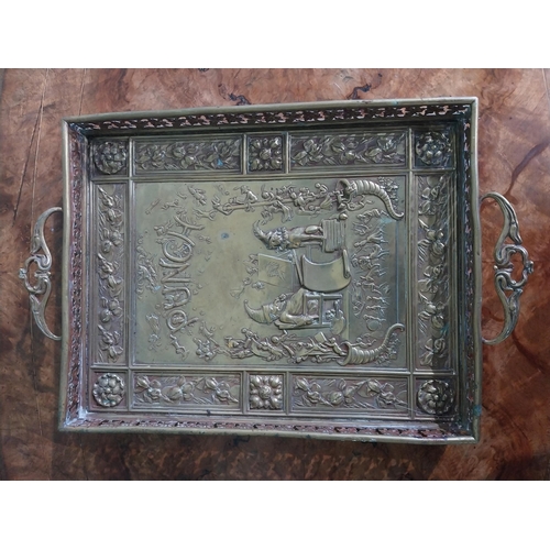 111 - Edwardian embossed brass Punch and Judy serving tray. {5 cm H x 36 cm W x 23 cm D}.