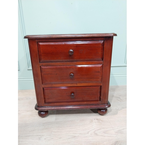 129 - Good quality mahogany bedside cabinet with three drawers on turned legs. [58 cm H x 55 cm W  x 45 cm... 