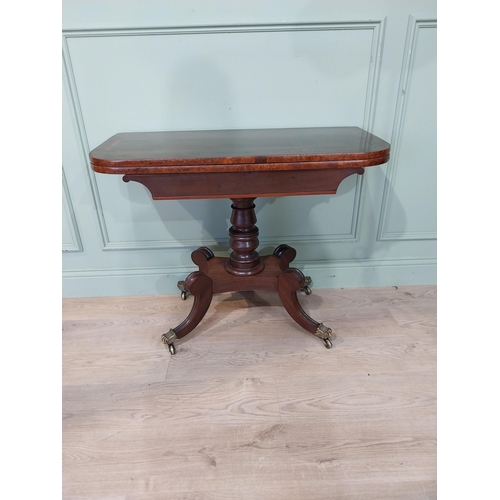 463 - Regency mahogany and rosewood card table on turned column on four outswept feet. {72 cm H x 91 cm W ... 