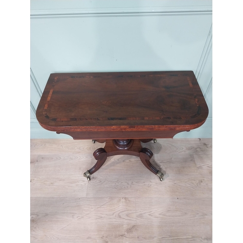 463 - Regency mahogany and rosewood card table on turned column on four outswept feet. {72 cm H x 91 cm W ... 