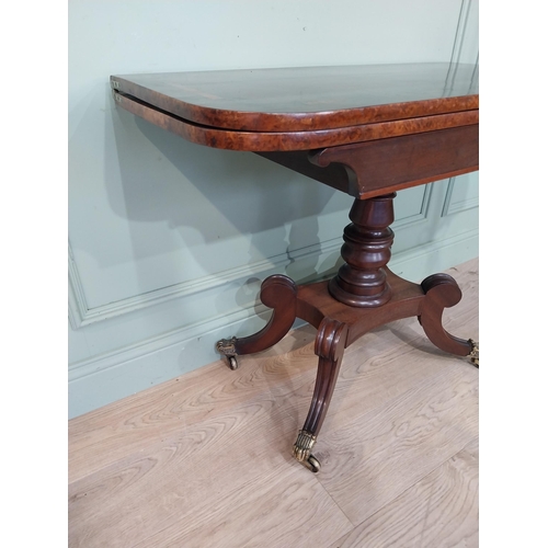 463 - Regency mahogany and rosewood card table on turned column on four outswept feet. {72 cm H x 91 cm W ... 