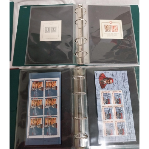 593 - Four albums of Helvetia stamps including sheet of 4 Switzerland 2000 World�s First Embroidery Stamps... 