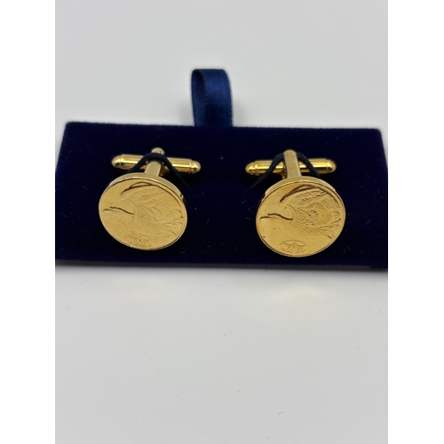 543 - Pair of gold coloured cufflinks with eagle detail.