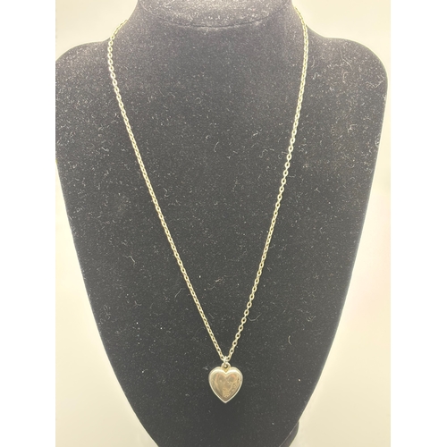 545 - Silver locket pendant in the shape of a heart.