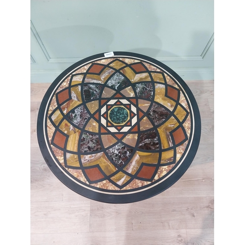 131 - Edwardian specimen marble occasional table on ebonised base. {72 cm H x 59 cm Dia.}.