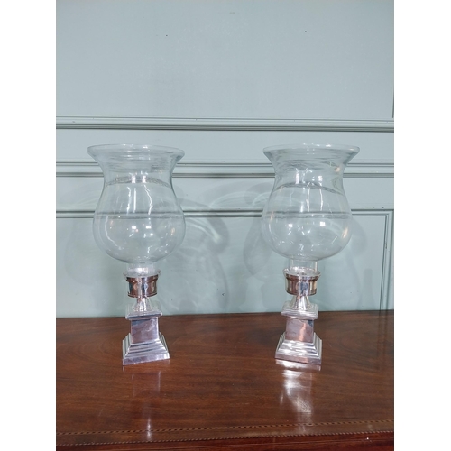 409 - Pair of chrome and glass candle holders. {48 cm H x 21 cm Dia.}.