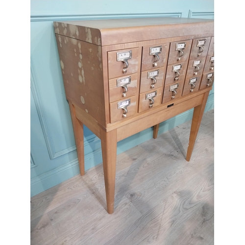 47 - 1950's oak bank of twelve drawers with brass handles  on tapered legs. {104 cm H x 84 cm W x 44 cm D... 