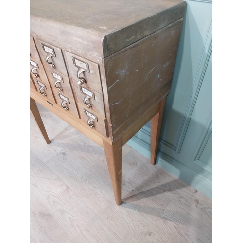 47 - 1950's oak bank of twelve drawers with brass handles  on tapered legs. {104 cm H x 84 cm W x 44 cm D... 