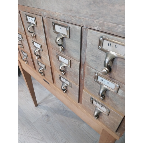 47 - 1950's oak bank of twelve drawers with brass handles  on tapered legs. {104 cm H x 84 cm W x 44 cm D... 