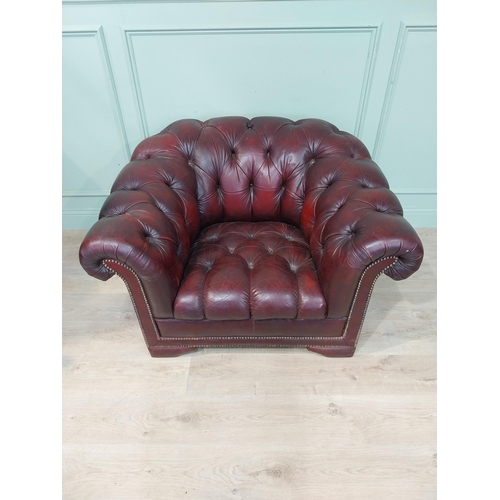 14 - Oxblood leather deep buttoned Chesterfield club chair. {70 cm H x 110 cm W x 92 cm D}.
