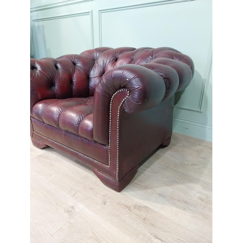 14 - Oxblood leather deep buttoned Chesterfield club chair. {70 cm H x 110 cm W x 92 cm D}.