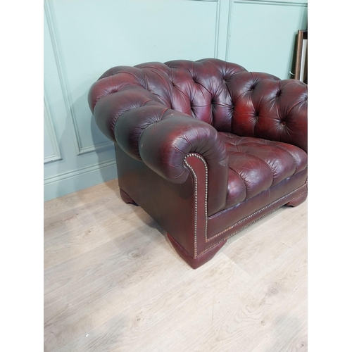 14 - Oxblood leather deep buttoned Chesterfield club chair. {70 cm H x 110 cm W x 92 cm D}.