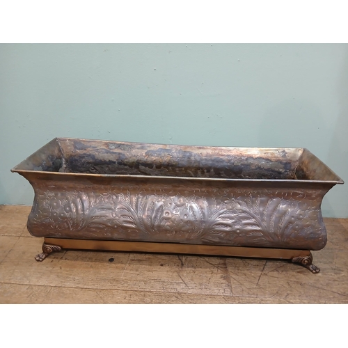 165 - Bronze planter on brass base with claw feet and hand hammered floral and leaf motifs. {H 28cm x W 80... 