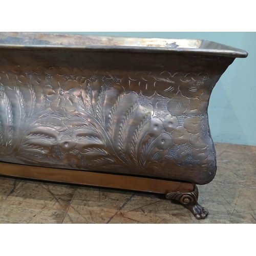 165 - Bronze planter on brass base with claw feet and hand hammered floral and leaf motifs. {H 28cm x W 80... 