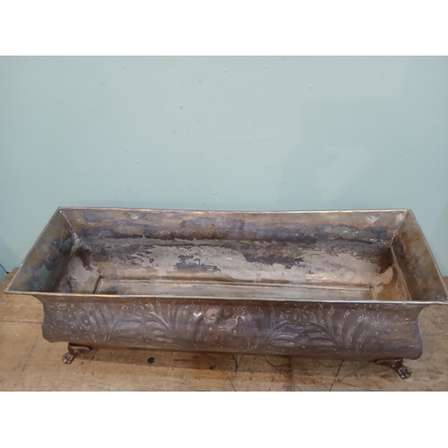 165 - Bronze planter on brass base with claw feet and hand hammered floral and leaf motifs. {H 28cm x W 80... 