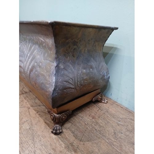 165 - Bronze planter on brass base with claw feet and hand hammered floral and leaf motifs. {H 28cm x W 80... 