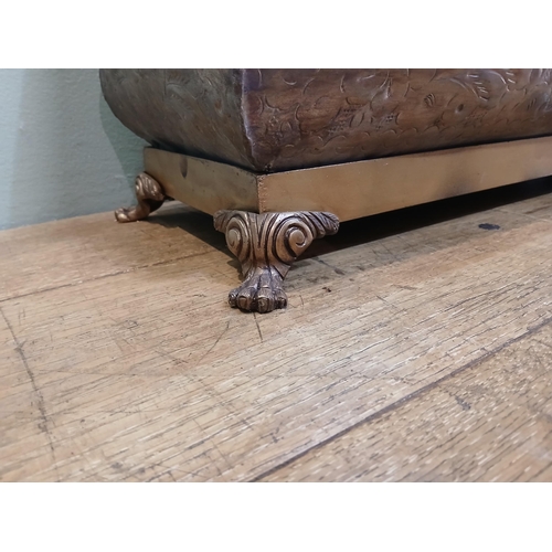 165 - Bronze planter on brass base with claw feet and hand hammered floral and leaf motifs. {H 28cm x W 80... 