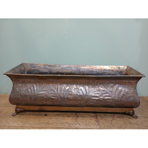 165 - Bronze planter on brass base with claw feet and hand hammered floral and leaf motifs. {H 28cm x W 80... 