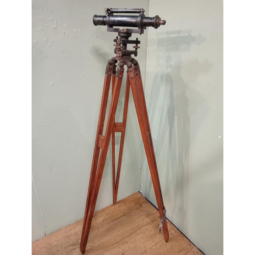 20 - 1900's brass Surveyor's theodolite mounted on an adjustable wooden tripod base. {168 cm H x 20 cm W ... 