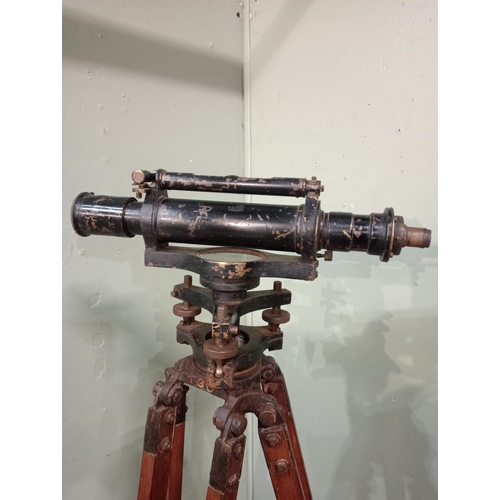 20 - 1900's brass Surveyor's theodolite mounted on an adjustable wooden tripod base. {168 cm H x 20 cm W ... 