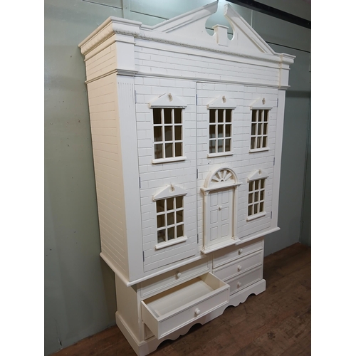 260 - Painted wooden wardrobe in the form of a Doll's House with three doors over three short drawers. {H ... 