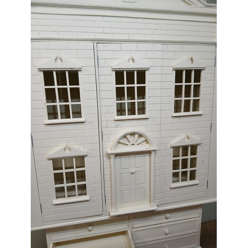 260 - Painted wooden wardrobe in the form of a Doll's House with three doors over three short drawers. {H ... 
