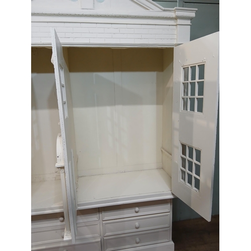 260 - Painted wooden wardrobe in the form of a Doll's House with three doors over three short drawers. {H ... 