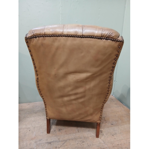 262 - Pair of deep buttoned leather upholstered wingback armchairs with studded detail.  {H 105cm x W 75cm... 