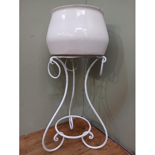 337 - Wrought iron scrolled plant stand with ceramic plant pot. {H 90cm x Dia 45cm }.  NOT AVAILABLE TO VI... 