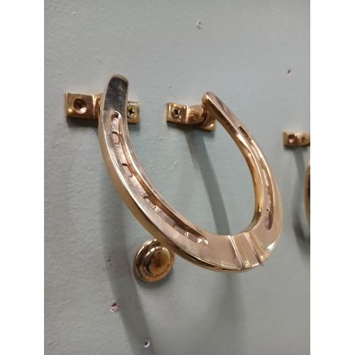 393 - Pair of solid brass door knockers in the form of Horse Shoes.  {H 11cm x w 10cm x D 3cm }.  NOT AVAI... 
