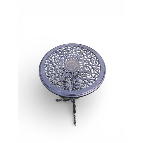 12 - Decorative cast iron garden table on three outswept legs. {70 cm H x 36 cm Dia.}.