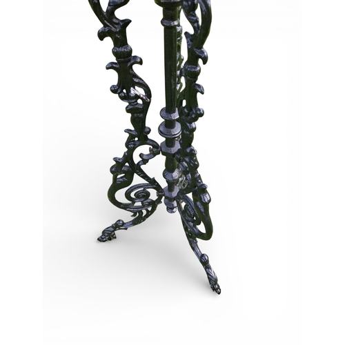 12 - Decorative cast iron garden table on three outswept legs. {70 cm H x 36 cm Dia.}.