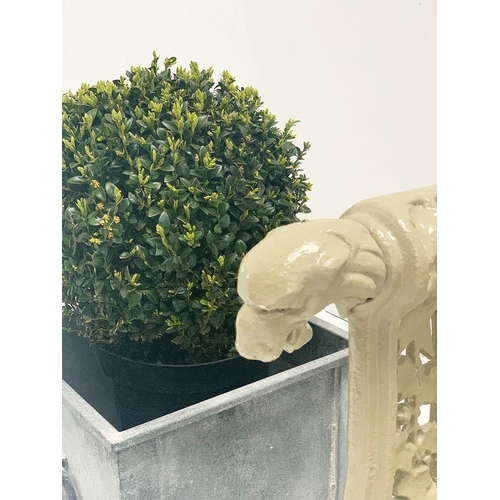 37 - Cast iron two seater garden bench with arms terminating in Dog's head with oak and ivy decoration in... 