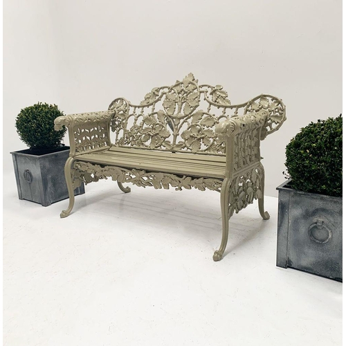37A - Cast iron two seater garden bench with arms terminating in Dog's head with oak and ivy decoration in... 