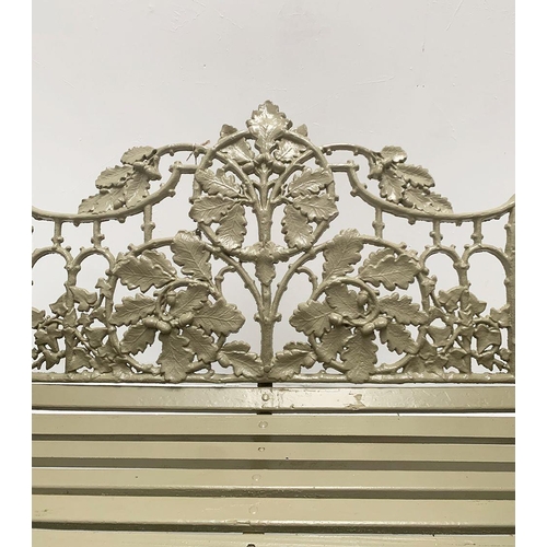 37A - Cast iron two seater garden bench with arms terminating in Dog's head with oak and ivy decoration in... 