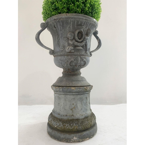38 - Lead garden oval urn on base with cherub decoration and scrolled handles. {76 cm H x 50 cm W x 38 cm... 