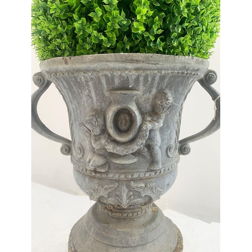 38 - Lead garden oval urn on base with cherub decoration and scrolled handles. {76 cm H x 50 cm W x 38 cm... 