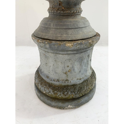 38 - Lead garden oval urn on base with cherub decoration and scrolled handles. {76 cm H x 50 cm W x 38 cm... 