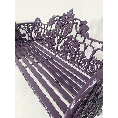 44 - Cast iron two seater garden bench with curved arms and oak and ivy decoration in the Coalbrookdale s... 