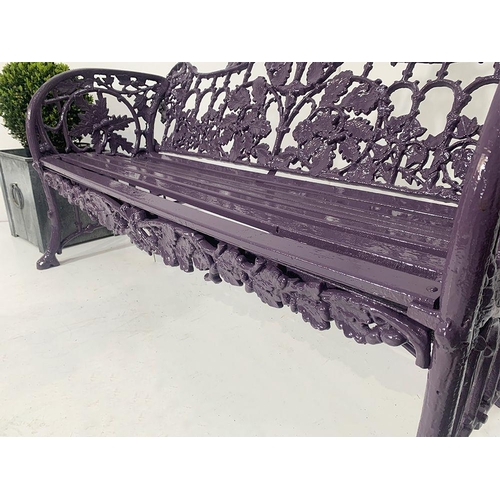 44 - Cast iron two seater garden bench with curved arms and oak and ivy decoration in the Coalbrookdale s... 