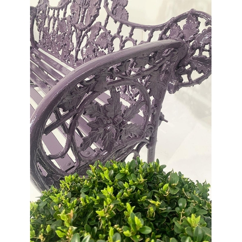 44 - Cast iron two seater garden bench with curved arms and oak and ivy decoration in the Coalbrookdale s... 